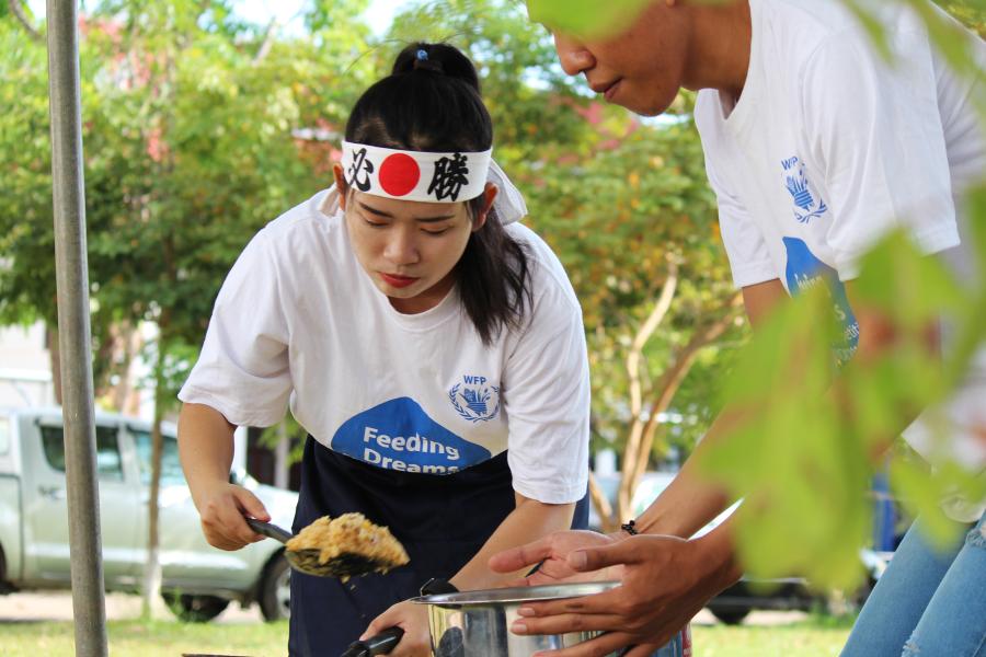 Participants of the healthy food cooking competition preparing their dish.