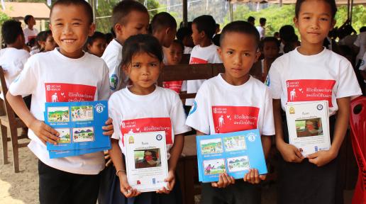 Kids are happy to receive the new UXO school curriculum textbooks.